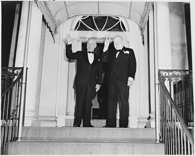 Photograph of Winston Churchill flashing his "V for Victory" sign and President Truman waving outside Blair House in... - NARA - 200108.jpg